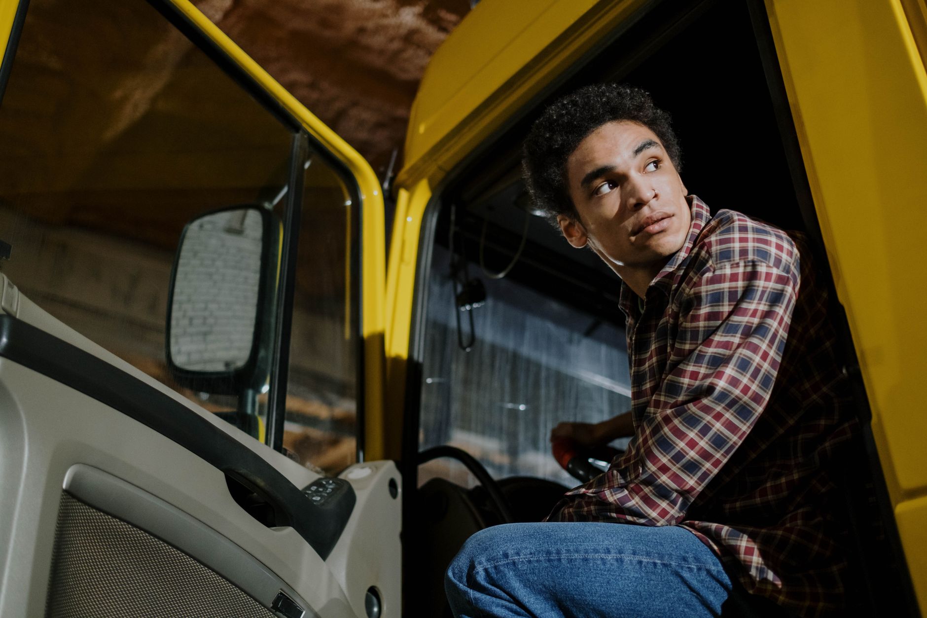 low angle shot of a man sitting in a truck